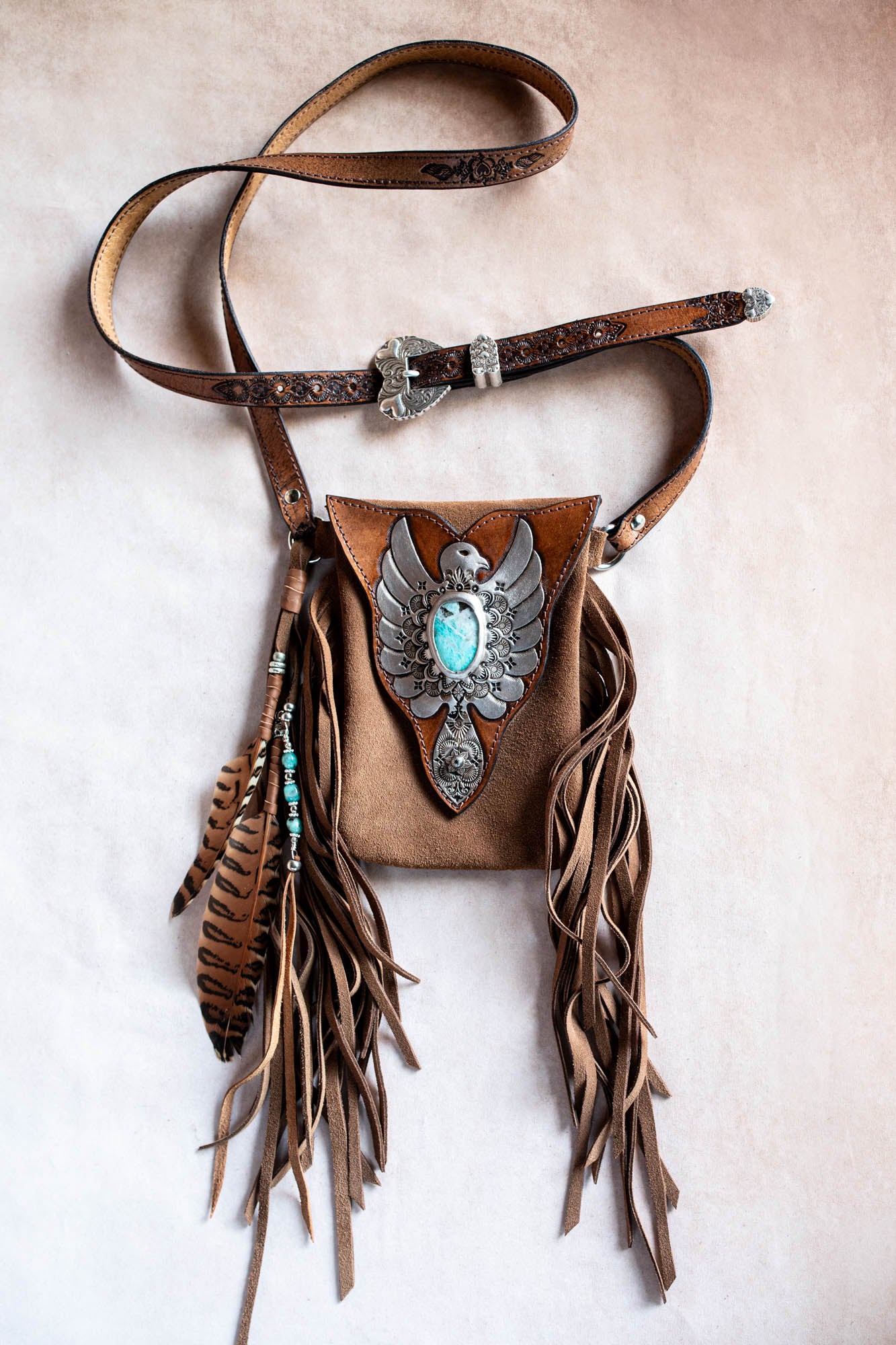 Brown leather bag with fringe and eagle emblem